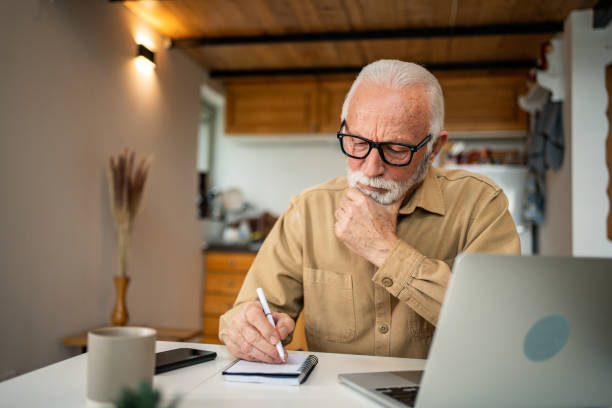 istock An elderly man, a pensioner, learns online, he spends his retirement days studying online, thus continuing his activities and still perfecting his skills. 1483467394