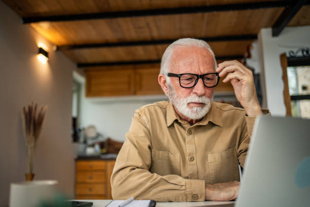 istock An elderly man, a pensioner, learns online, he spends his retirement days studying online, thus continuing his activities and still perfecting his skills. 1483467455