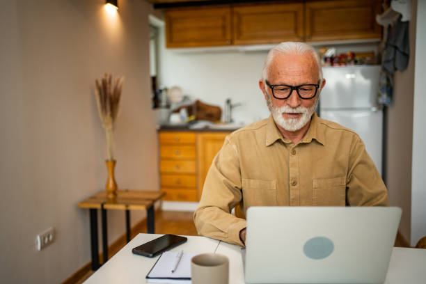 istock An elderly man, a pensioner, learns online, he spends his retirement days studying online, thus continuing his activities and still perfecting his skills. 1483467533