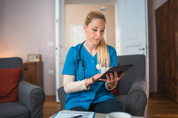 istock Caucasian Nurse Using Digital Tablet At Patients Home 1483467740