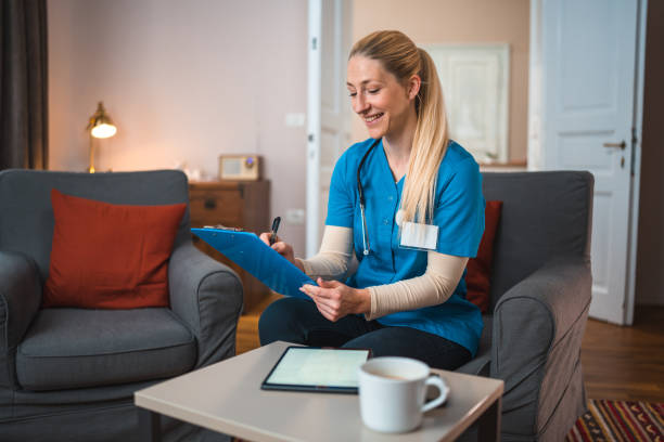 istock Caucasian Caregiver At Patients Home Using Digital Tablet 1483467748