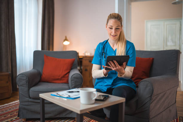 istock Caucasian Nurse Using Digital Tablet At Patients Home 1483467750