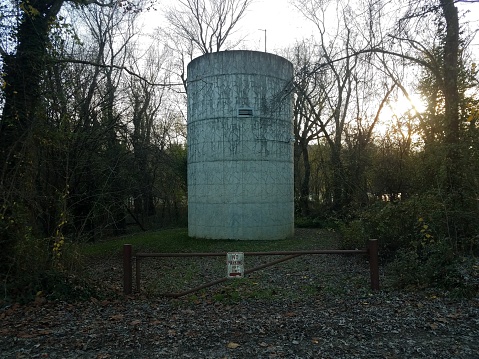 large water tower or storage tank with no parking sign in the woods