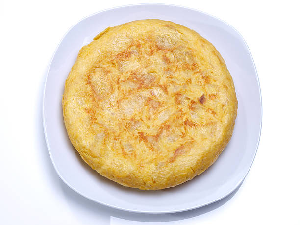 Spanish omelet Spanish omelet, “Tortilla de patatas”, made with potatoes, eggs, olive oil, and salt...  It is eaten as starter, main dish, snack or for breakfast. Served on dish or as sandwich. tortilla de patatas stock pictures, royalty-free photos & images