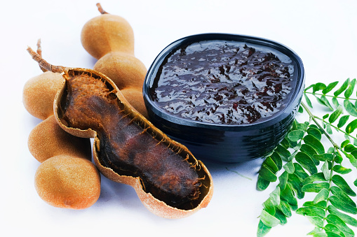 fresh Delicious ripe tamarinds, tamarind with brown pulp with green leaf.