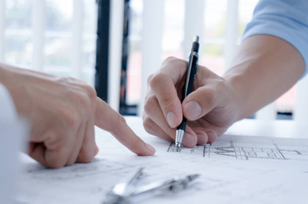 istock Colleagues interior designer Corporate Achievement Planning Design on blueprint Teamwork Concept with compasse. 1483470302