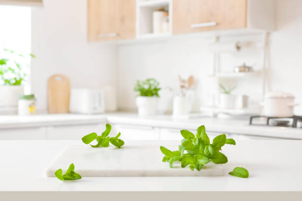istock Marble cutting board with mint leaves on blurred kitchen background 1483470547