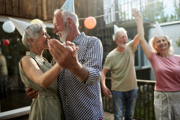 istock Happy senior couples dancing during a Birthday party on a terrace. 1483470983