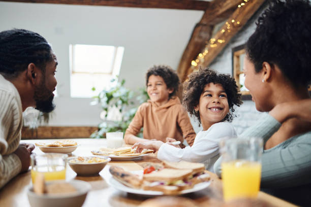 istock Happy black parents and their kids talking during breakfast. 1483472168