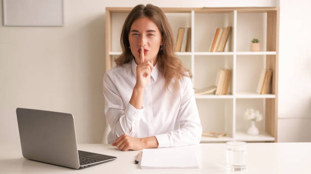 istock Work secret elegant woman keep silence conspirator 1483472240