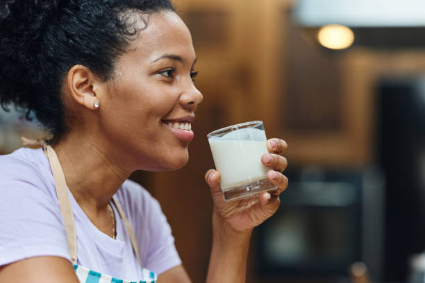 istock Happy black woman drinking fresh milk at home. 1483472421