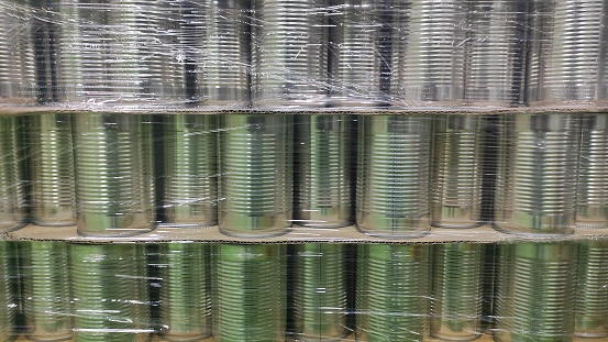 An aluminum empty can covered with plastic in warehouse in order to keep it clean