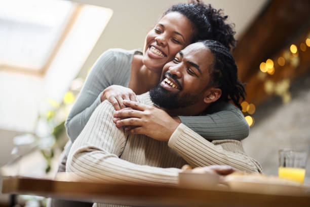 istock Happy black couple embracing at home. 1483472863