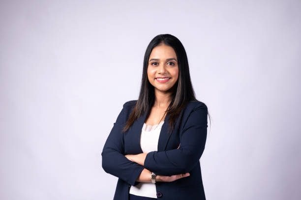 smiling young woman professional in formal wear with arms crossed and looking at camera - reduction looking at camera finance business imagens e fotografias de stock
