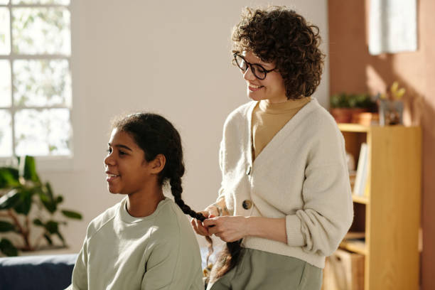 istock Smiling mom making hairstyle to her adopted child 1483474544