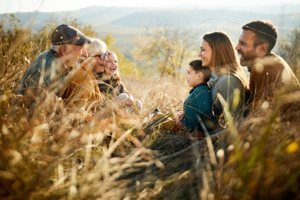 istock Happy extended family talking in autumn day on a hill. 1483477183