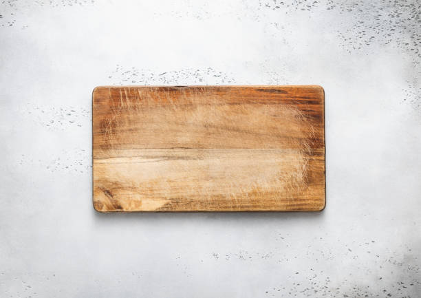 istock Empty scratched wooden cutting chopping kitchen board on light background.Top view. 1483478322