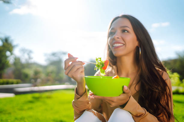 istock young woman eating fresh vegetable 1483479099
