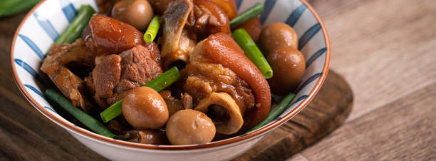 Taiwanese traditional food pork knuckle in a bowl Close up of Taiwanese traditional food pork knuckle in a bowl on rustic table background. pork hock stock pictures, royalty-free photos & images