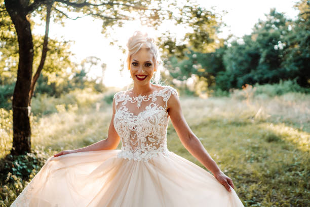 Beautiful young bride enjoying sunny day in nature