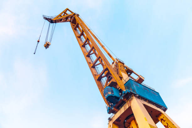 istock Harbor crane on a background of blue sky, bottom view. 1483484683