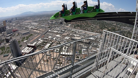 Las Vegas, USA - Aug 2018: XScream thrill ride at top of Stratosphere Tower in Las Vegas. It's a roller coaster-like ride that hangs off the side of tower and tilts passengers 30 feet over the edge