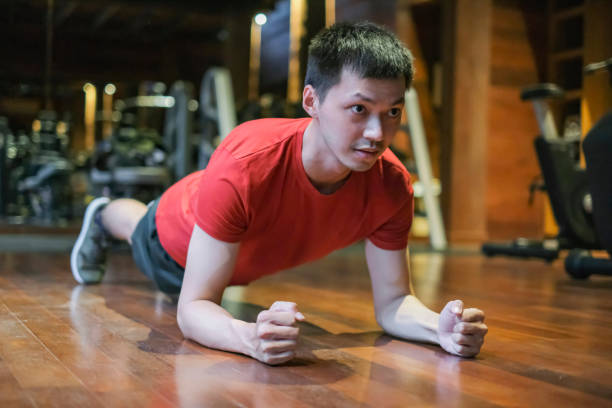 istock Asian Young Man Exercise Plank Position at Gym 1483485591