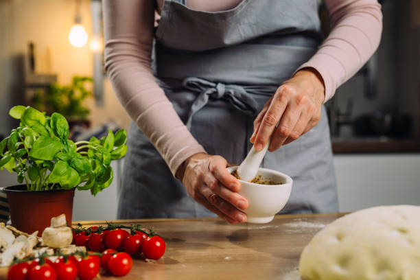 istock woman prepares pizza at home 1483485997
