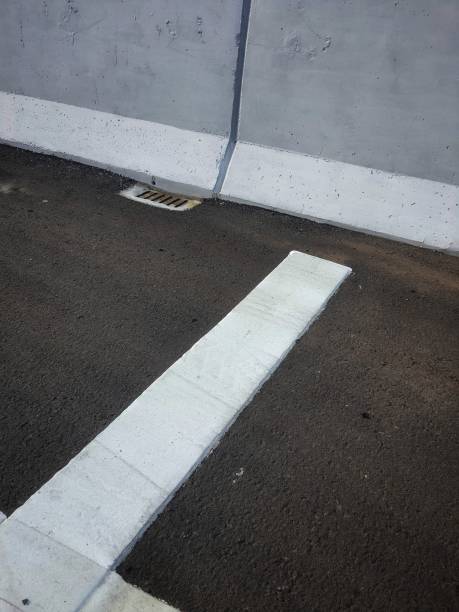 a white marking on a new highway. this is one of the rumble strip markings installed before the toll gate to slow down the speed of vehicles - rumble strip imagens e fotografias de stock
