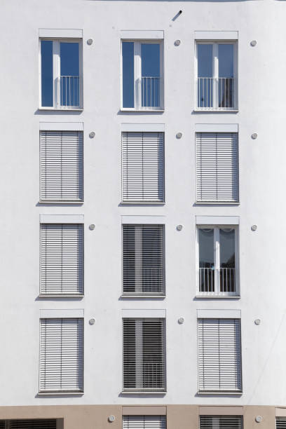 istock white windows with shutters pulled down on a white house wall, Bremen, Germany, Europe 1483487234