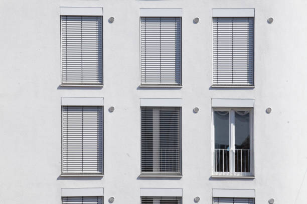 istock white windows with shutters pulled down on a white house wall, Bremen, Germany, Europe 1483487235