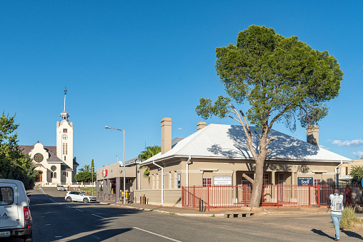 Prieska, South Africa - Feb 28 2023: A street scene, with businesses, people, vehicles and a church, in Prieska in the Northern Cape Province