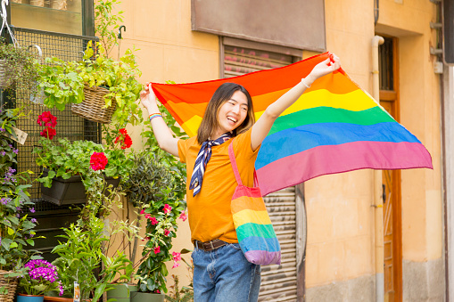 Proud and Happy: Young Chinese Man Shows Support for LGBT Rights Among Blooming Flowers on the Street
