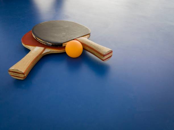 istock a table tennis racket and ball resting on a blue surface 1483492784