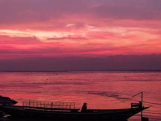 Pink sky in padma river with boat