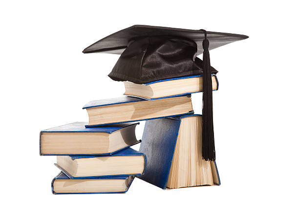 istock books with black cap of bachelor isolated on white 148349383