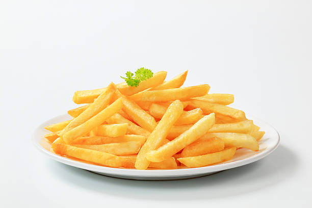 Plate of delicious looking French fries Heap of French fries on a plate plate of fried food stock pictures, royalty-free photos & images