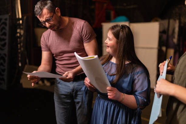 istock Young woman with down syndrome practicing her lines with her colleagues before a performance 1483496789