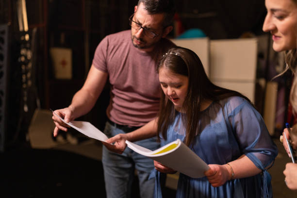 istock Young woman with down syndrome practicing her lines with her colleagues before a performance 1483496881