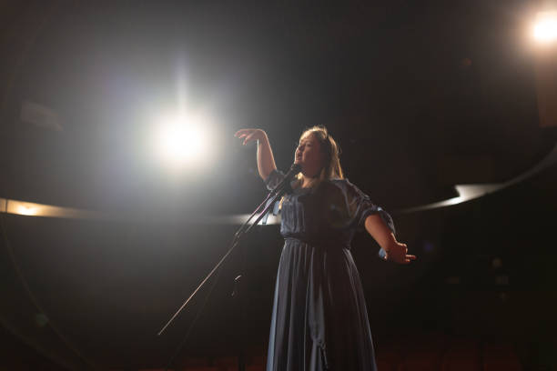 istock Young confident woman with down syndrome singing indoors 1483497641