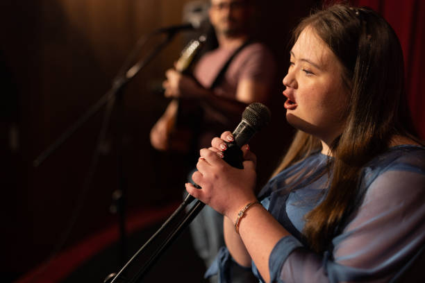 istock Young woman with down syndrome singing in a band 1483497785