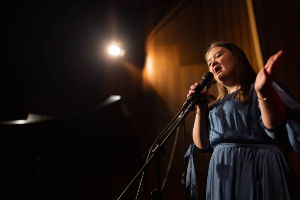istock Young confident woman with down syndrome singing indoors 1483497789