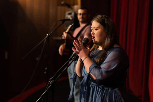istock Young woman with down syndrome singing in a band 1483497807