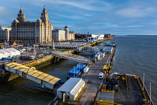 Liverpool waterfront and the three graces (The Royal Liver, the Cunard and the Port of Liverpool Buildings) on the River Mersey in North West England, UK.