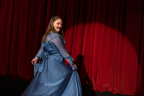 istock Young woman with down syndrome dancing on stage 1483498312