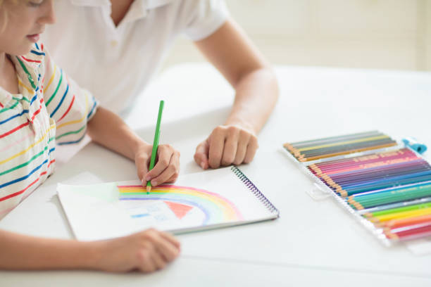 istock Child drawing. School kid painting a picture. 1483499370