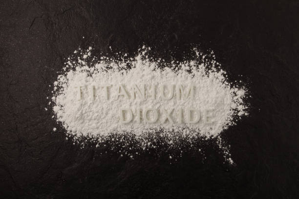 istock White chemical powder scattered on dark stone surface. Food coloring, E171. Titanium dioxide, TiO2. Pigment present in of paint, food, toothpastes,  and cosmetic products 1483499587