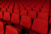 Empty theatre with red seats in low light