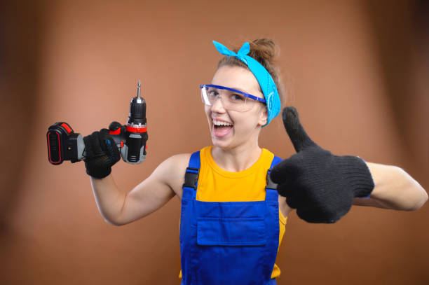 istock Young smiling practical woman working with screwdriver showing thumbs up gesture. Portrait of a builder or handyman with a screwdriver in his hand 1483501162