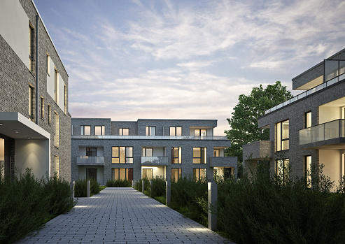 3d rendering of a modern apartment complex in the evening